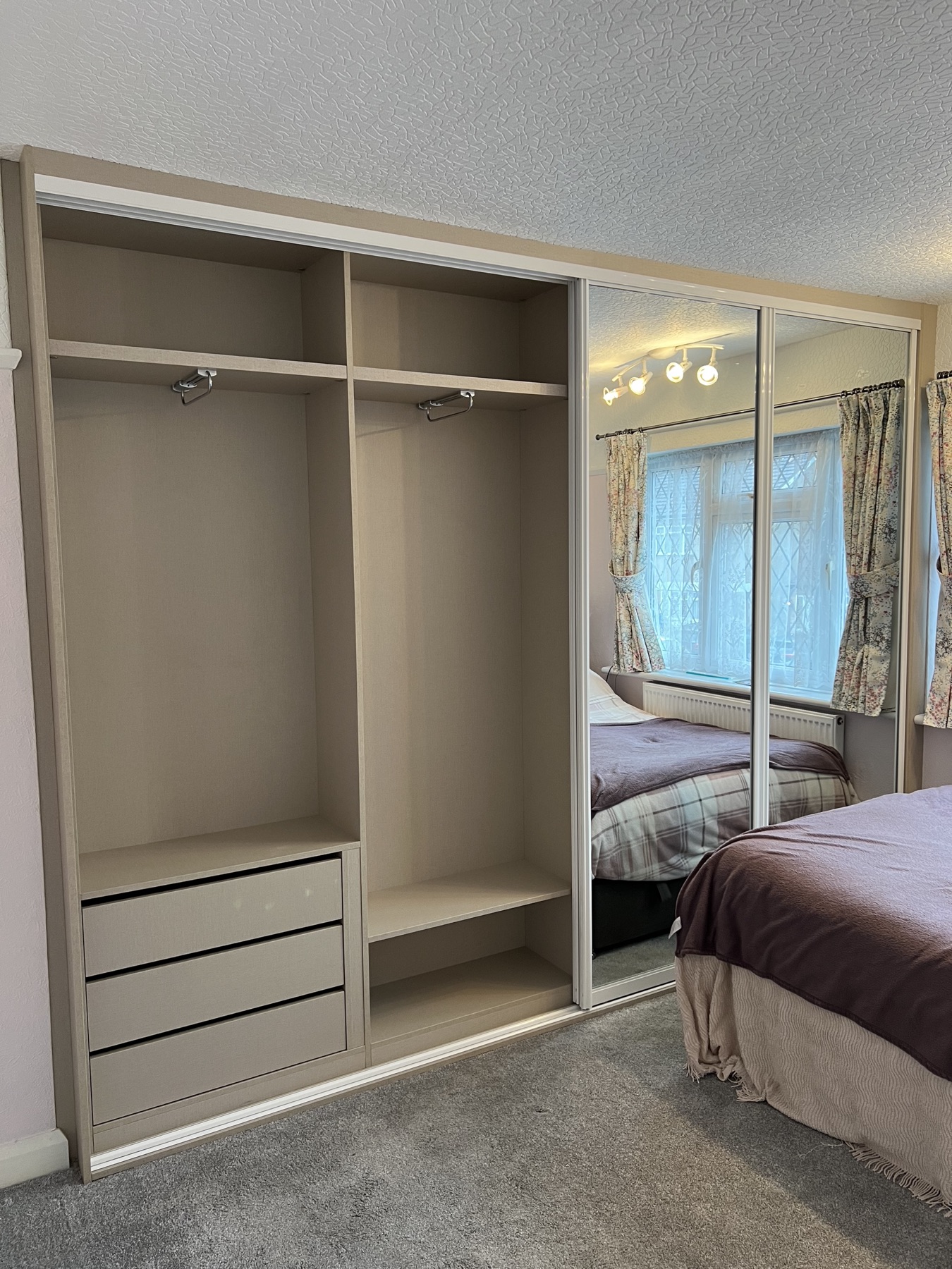 Completed mirrored sliding wardrobe with visible fitted internals