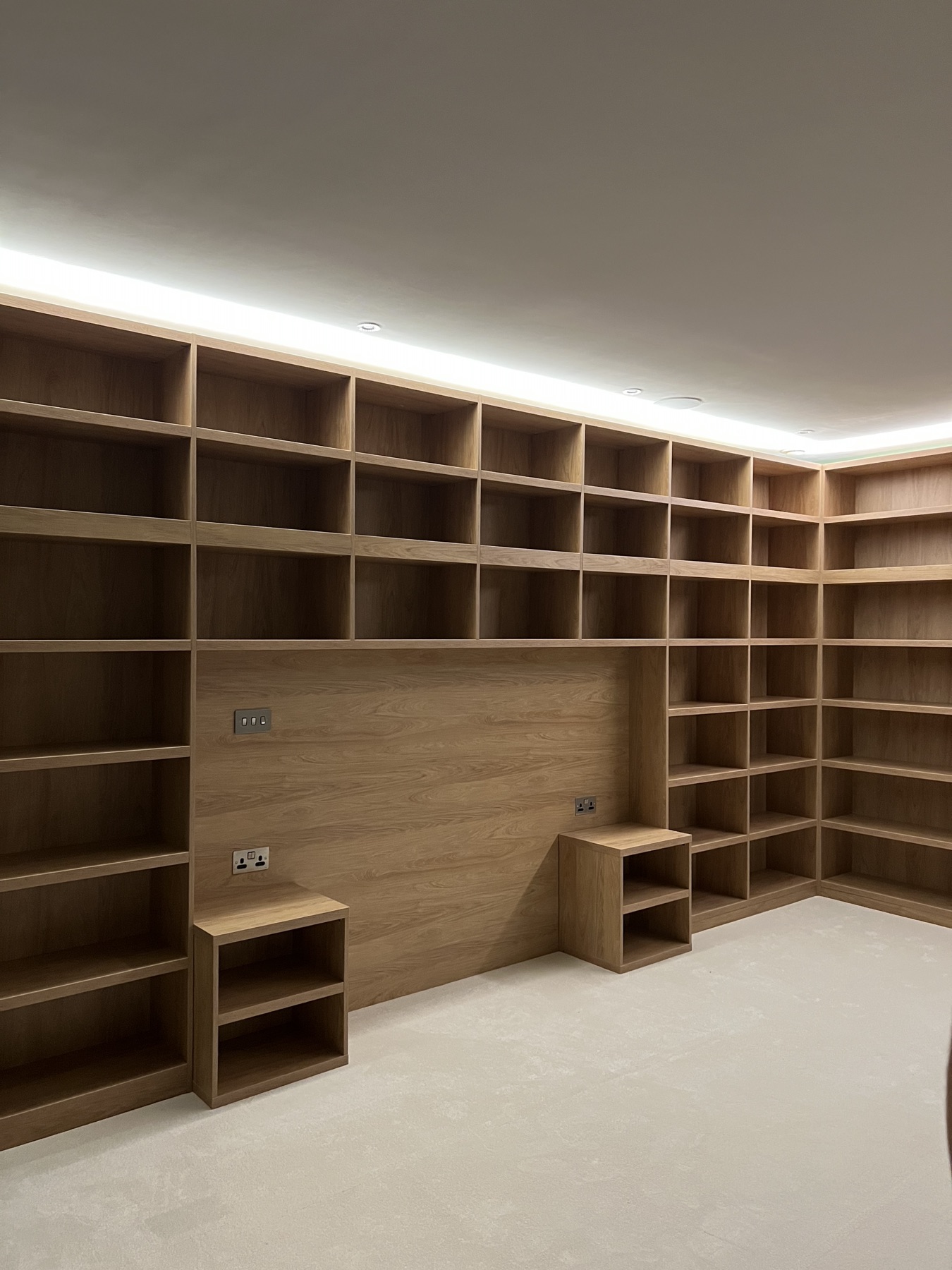 Close view of fitted shelving wrapping around two walls